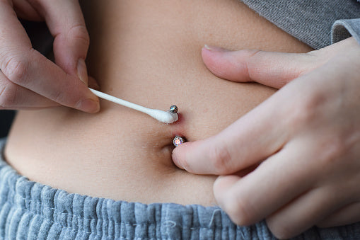 how to heal your belly button piercing faster