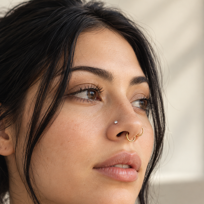 Woman with a nostril stud and gold nose hoops