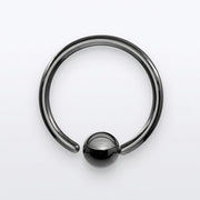 18G PVD coated steel black nose ring with a fixed ball, overhead flat-lay view on a white background
