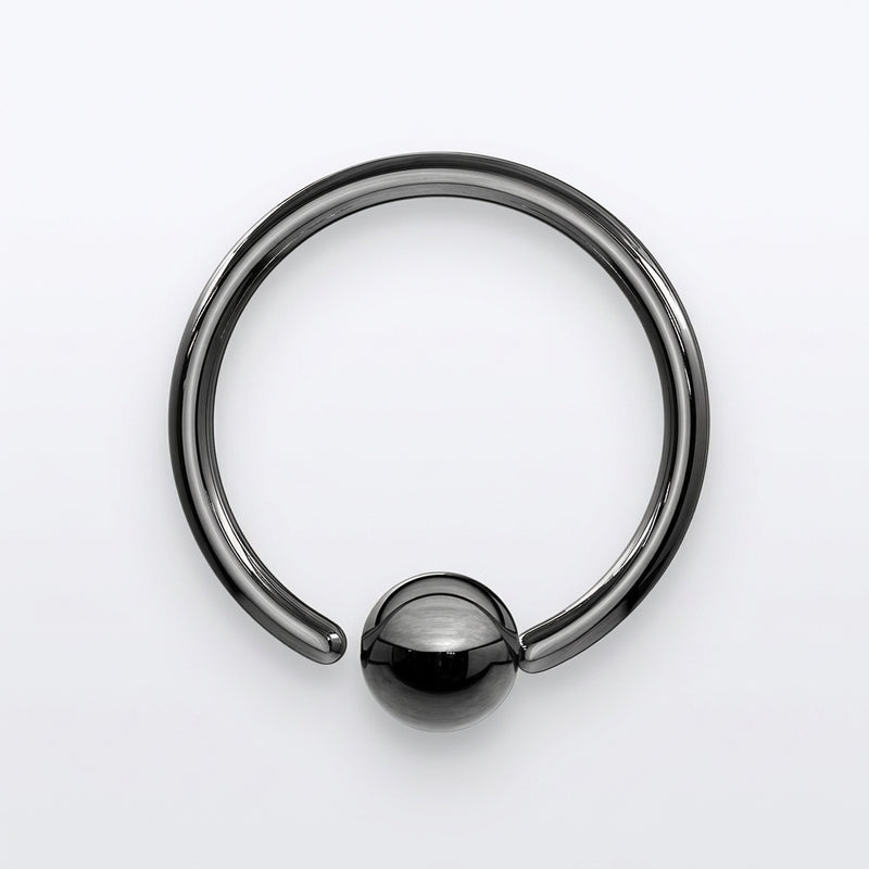 18G PVD coated steel black nose ring with a fixed ball, overhead flat-lay view on a white background