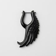16G organic water buffalo horn earring with a carved black angelic wing design and straight metal pin closure.