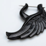 16G organic water buffalo horn earring in an angelic wing design with a metal pin, close-up view