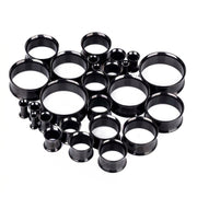 6G-1" PVD coated steel double flared eyelets with black finish, overhead view of multiple sizes