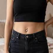 14G surgical steel navel ring with double clear CZ gems, shown worn in a navel piercing