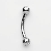 16G titanium curved eyebrow barbell with clear CZ gem balls, overhead view on a white background