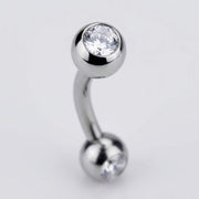 16G titanium curved eyebrow barbell with bezel-set clear CZ gem balls, close-up detail