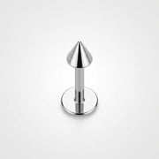 16G titanium labret stud with a flat back disc and polished cone spike end, standing upright on white