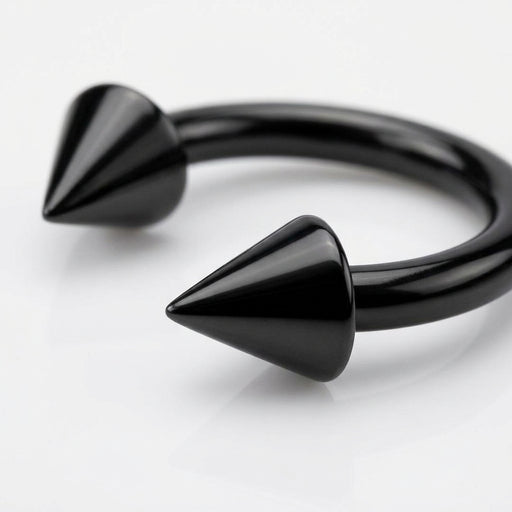 14G black PVD coated steel circular bent barbell with spike ends, close-up detail on a white surface