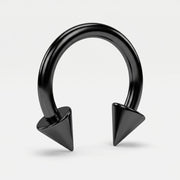 14G PVD coated steel circular bent barbell with black spike ends, three-quarter view on a white background