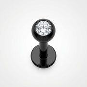 16G black surgical steel labret stud with a clear CZ gem ball, top-down view on white background