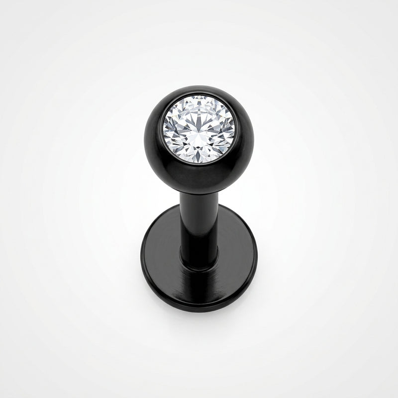 16G black surgical steel labret stud with a clear CZ gem ball, top-down view on white background