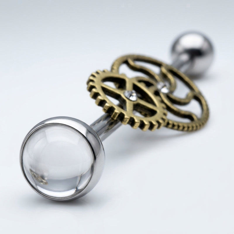 14G surgical steel industrial barbell with brass steampunk gears, clear CZ gems, and a clear dome end, close-up