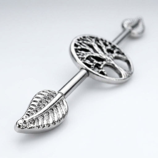 14G surgical steel industrial barbell with Tree of Life design and detailed leaf ends, close-up view