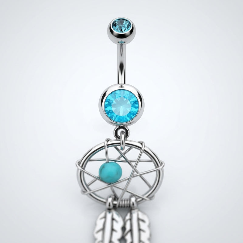 14G surgical steel belly ring with light blue gems, dream catcher dangle, and feather charms, close-up front view