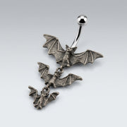 14G surgical steel navel ring with curved barbell, polished ball, and three cascading antique silver gothic bats.