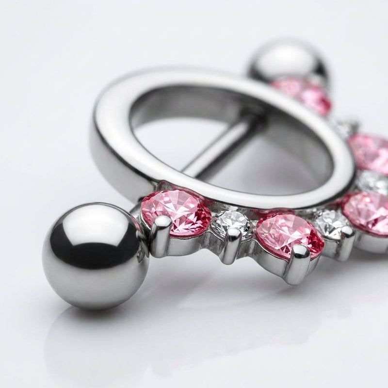 14G surgical steel nipple shield with half circle pink and clear CZ gems, straight barbell with ball ends, close-up