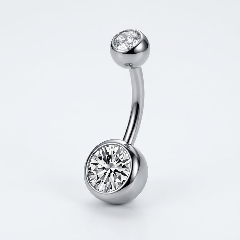 14G titanium navel ring with double clear bezel-set CZ gems, curved barbell in a three-quarter view.