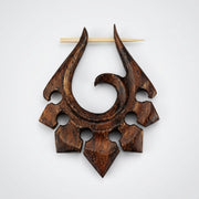 16G Sono wood tribal ornament earring with a hand-carved spiral design, notched edges, and a light wood pin, top view