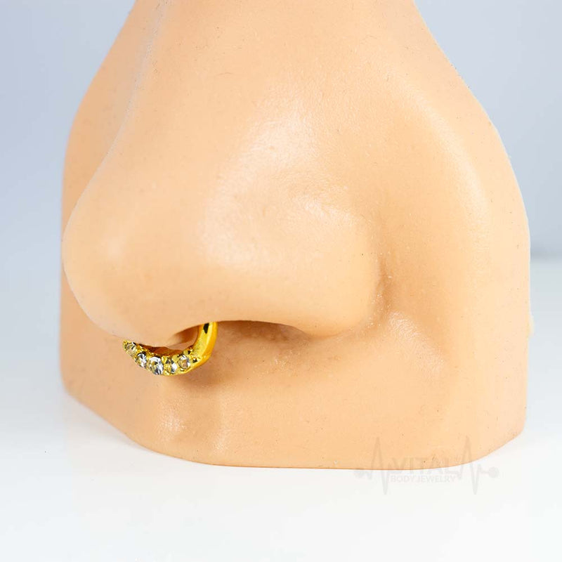 16G surgical steel septum clicker with five cubic zirconia gems and secure clicker design for comfortable wear.