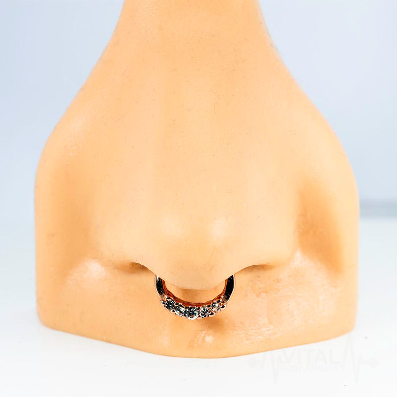 16G PVD coated surgical steel septum clicker with five cubic zirconia gems for a sparkling touch and a secure design.
