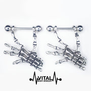 14G surgical steel nipple rings with lightweight skeleton hands dangle design for a unique, macabre style and comfortable wear.