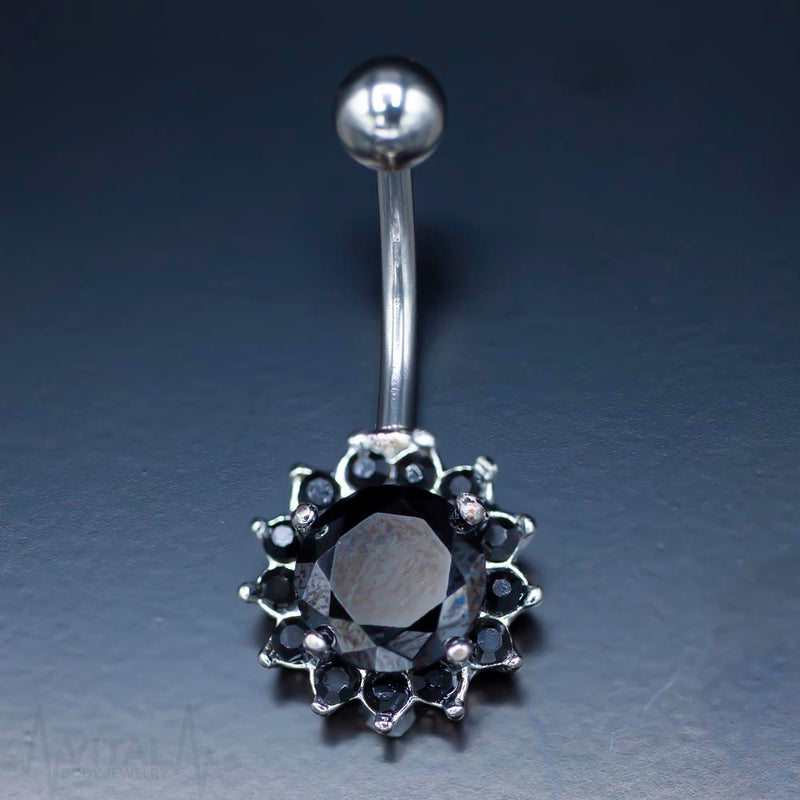 14G surgical steel belly ring with cubic zirconia flower design for a glamorous and comfortable fit.