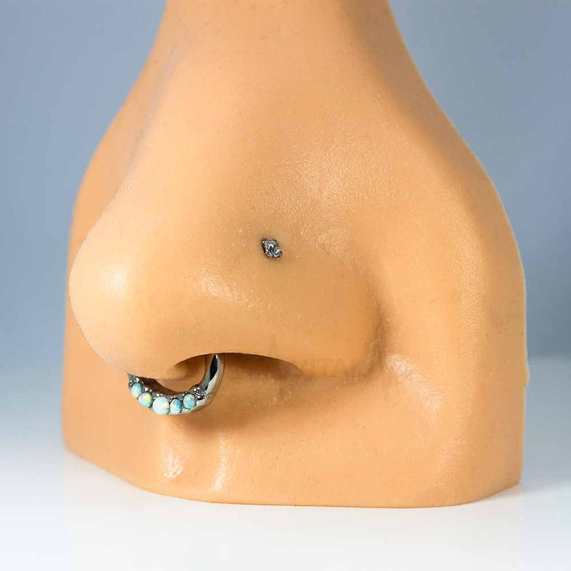 16G surgical steel septum ring with five white opals, featuring a clicker design for easy wear and a unique, elegant look.