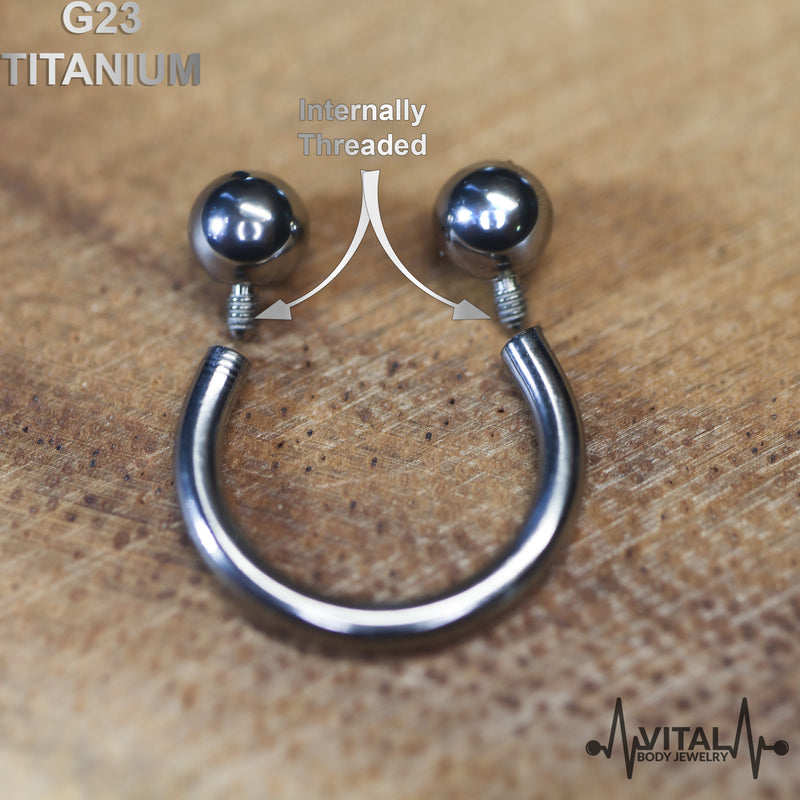 14G titanium septum ring with internally threaded design for easy wear, hypoallergenic material for sensitive skin, and smooth mirror finish.