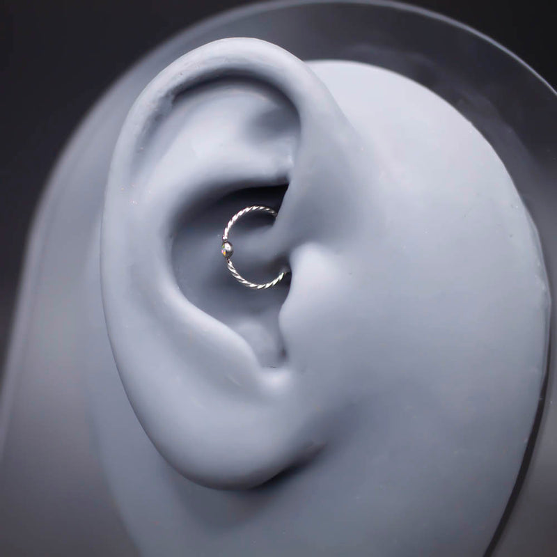 20G PVD coated surgical steel nose ring with twisted design and cubic zirconia gem ball for a stylish look.