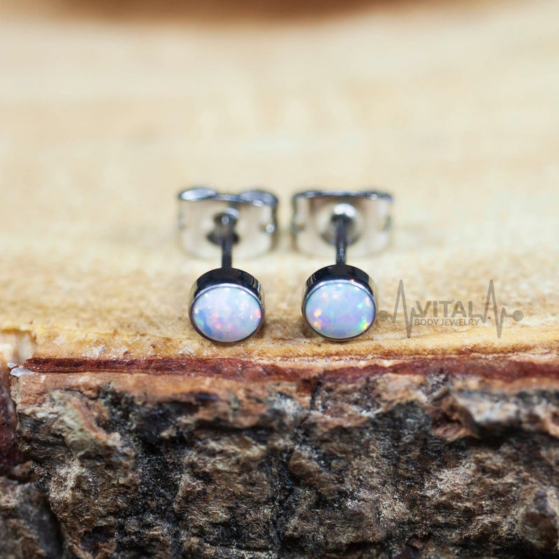 20G titanium stud earrings with 4mm opal gems in white, aqua, and purple, designed for sensitive ears and everyday comfort