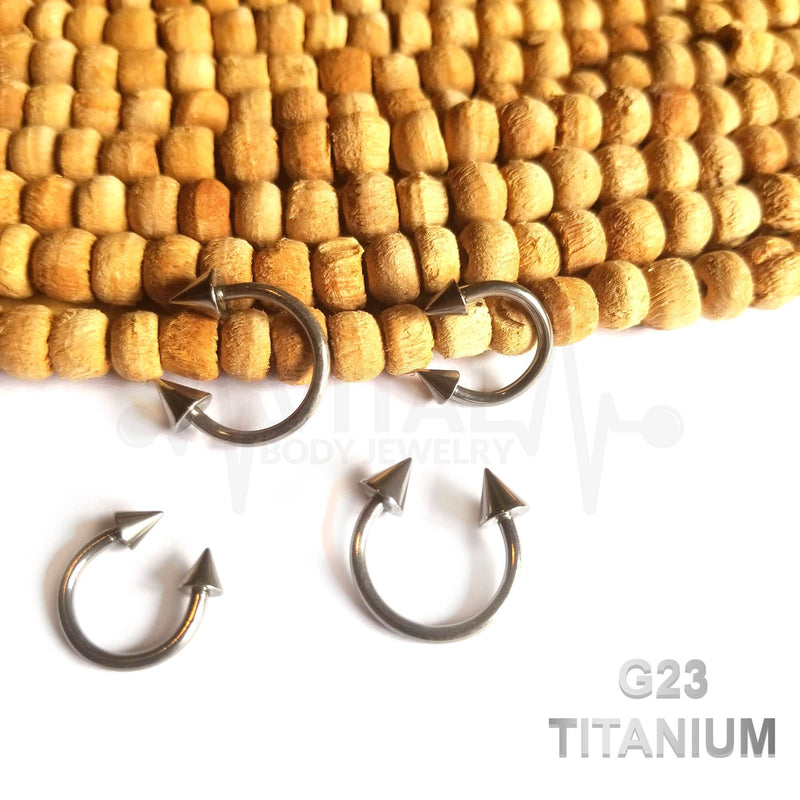 14G titanium septum ring with spike ends, externally threaded design for secure fit available in 3/8" and 1/2" sizes.