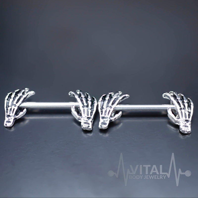 14G surgical steel nipple rings with skeleton hand design for unique body art, made for comfort and durability.