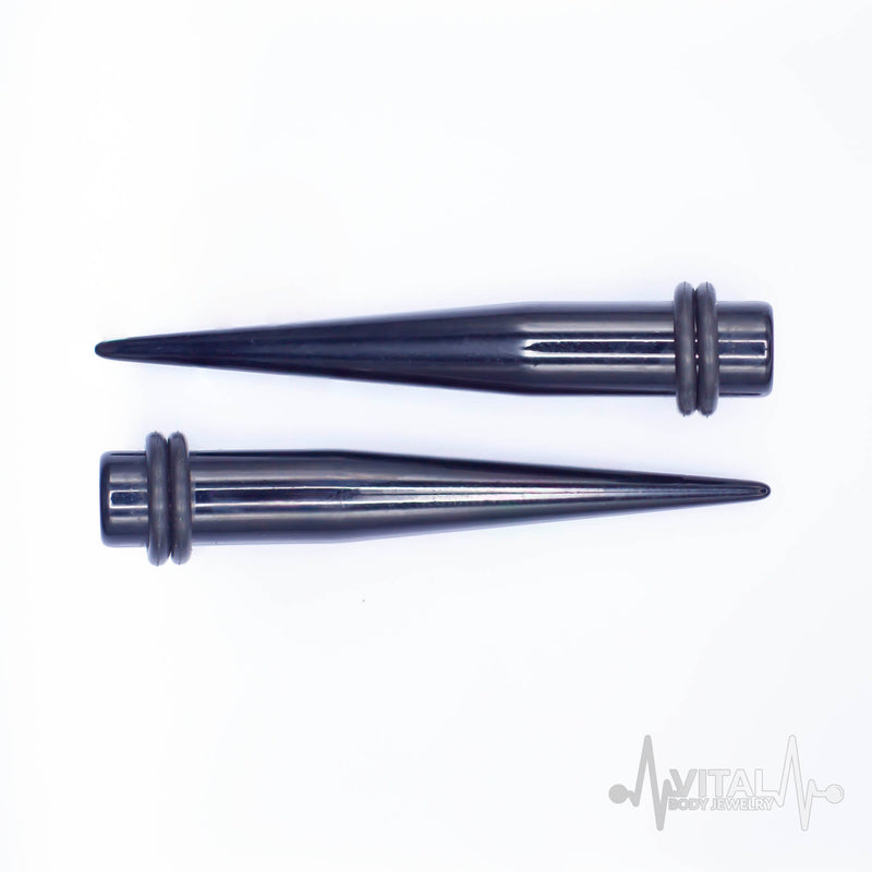 12G black acrylic ear stretchers with rubber o-rings for comfortable wear, designed for secure fit and effortless styling.