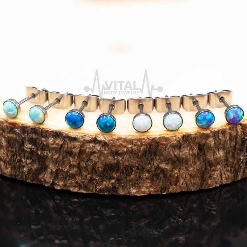 20G titanium stud earrings with 4mm opal stones in white, aqua, and purple colors, featuring a smooth polished finish for comfortable wear