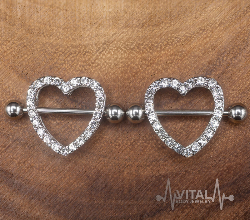 14G surgical steel nipple shields with heart design and cubic zirconia gems for a romantic touch and secure fit