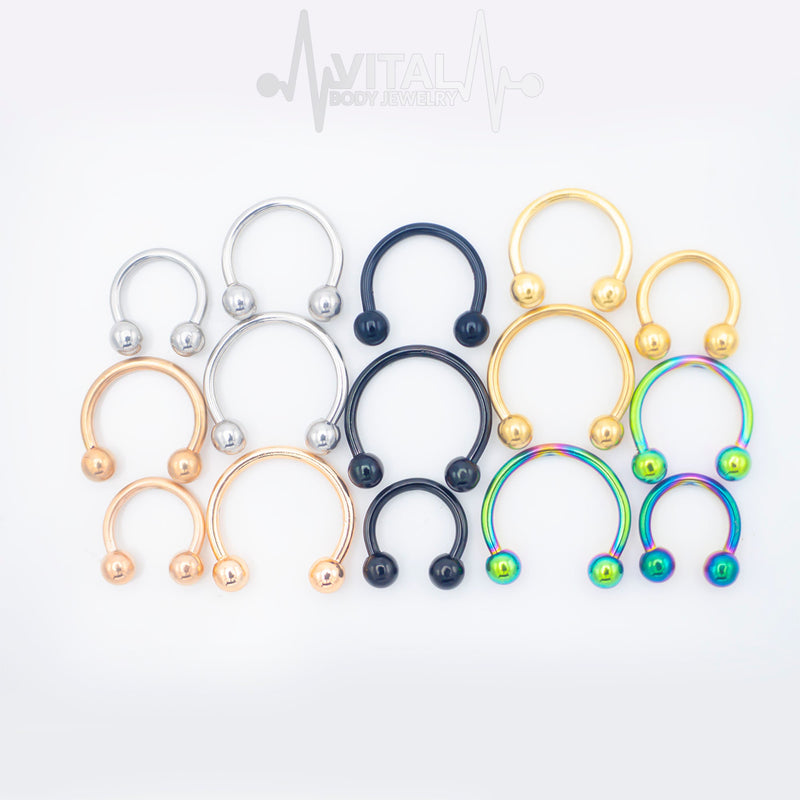 16G surgical steel septum ring in horseshoe design with ball ends, featuring a lustrous PVD coating for durable wear.