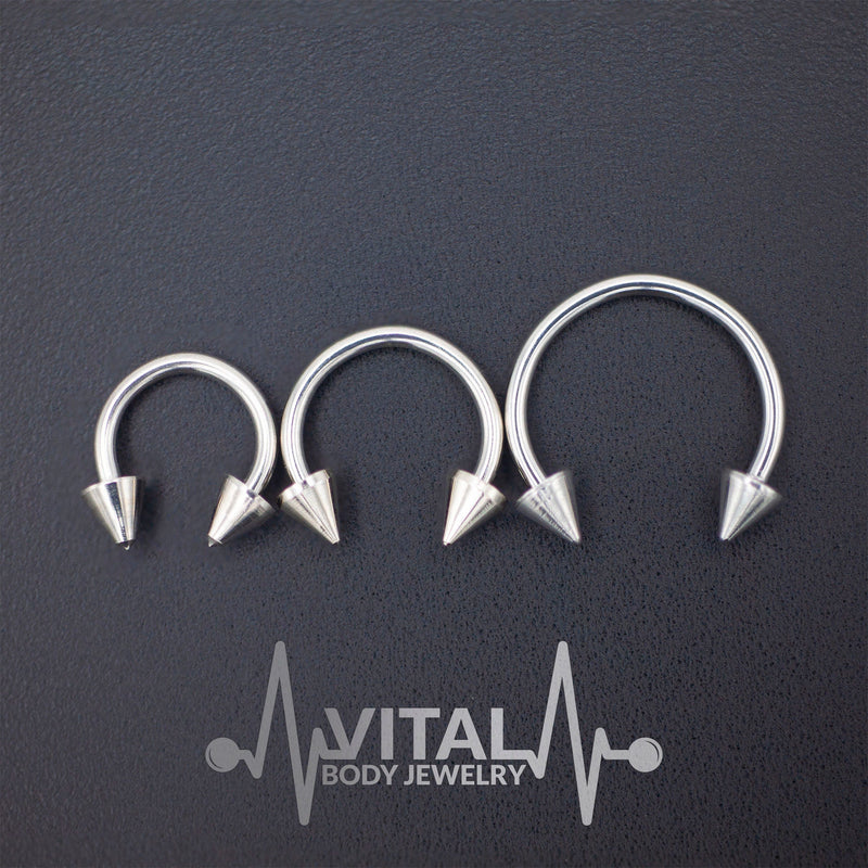 16G surgical steel septum ring with spike ends, featuring a PVD coating for durability and available in multiple diameters.
