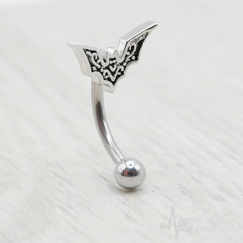 16G surgical steel eyebrow ring with bat design, featuring a 10mm bat charm and 3mm ball end for unique piercing style