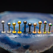 16G surgical steel labret stud with 3mm jeweled ball end, designed for lip and cartilage piercings in multiple colors.
